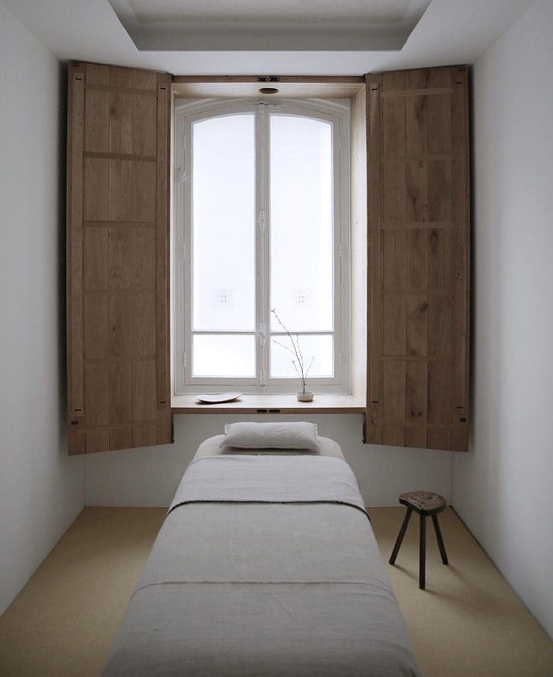 a bed in a room with a window