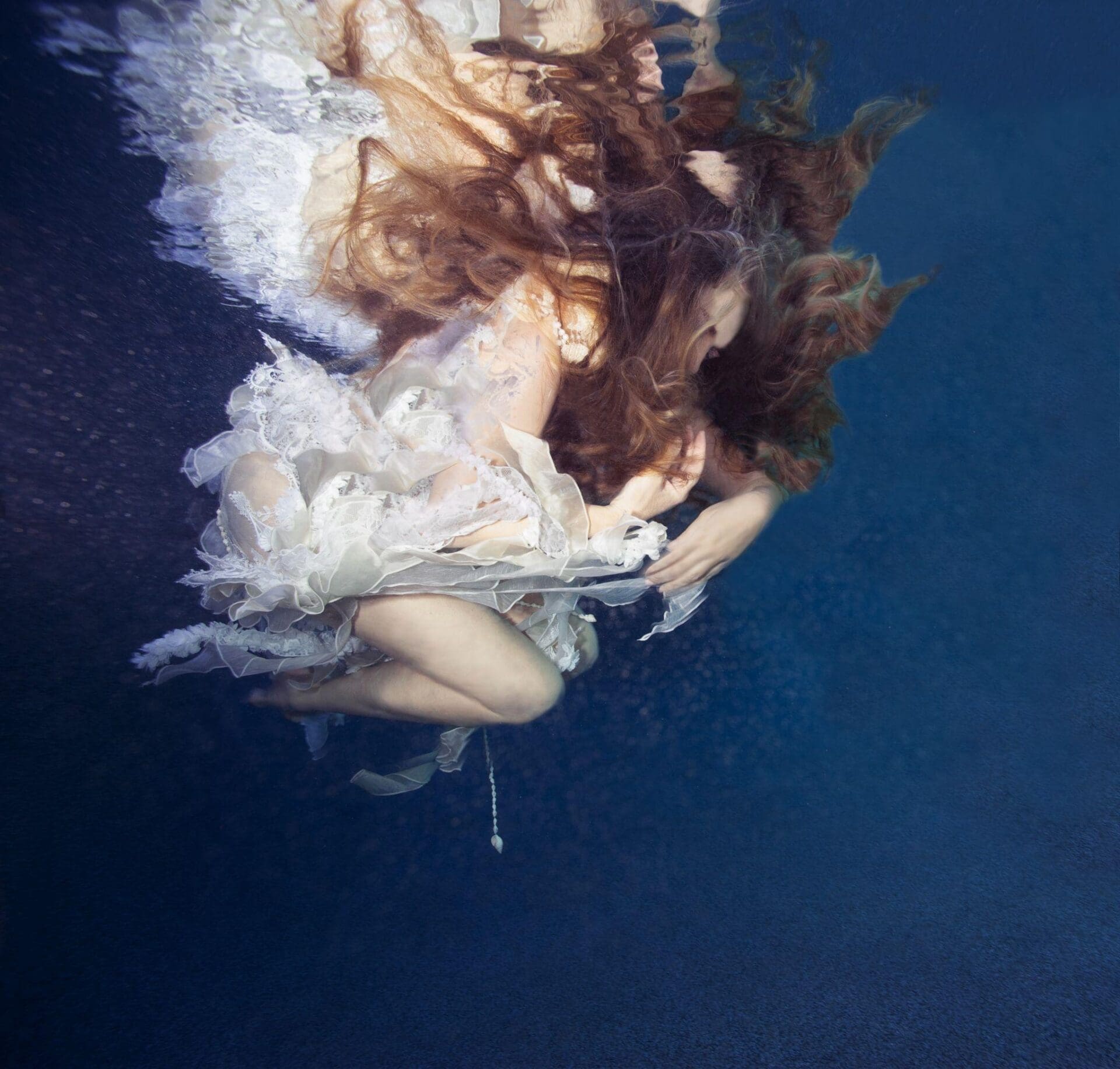 a person in a white dress underwater